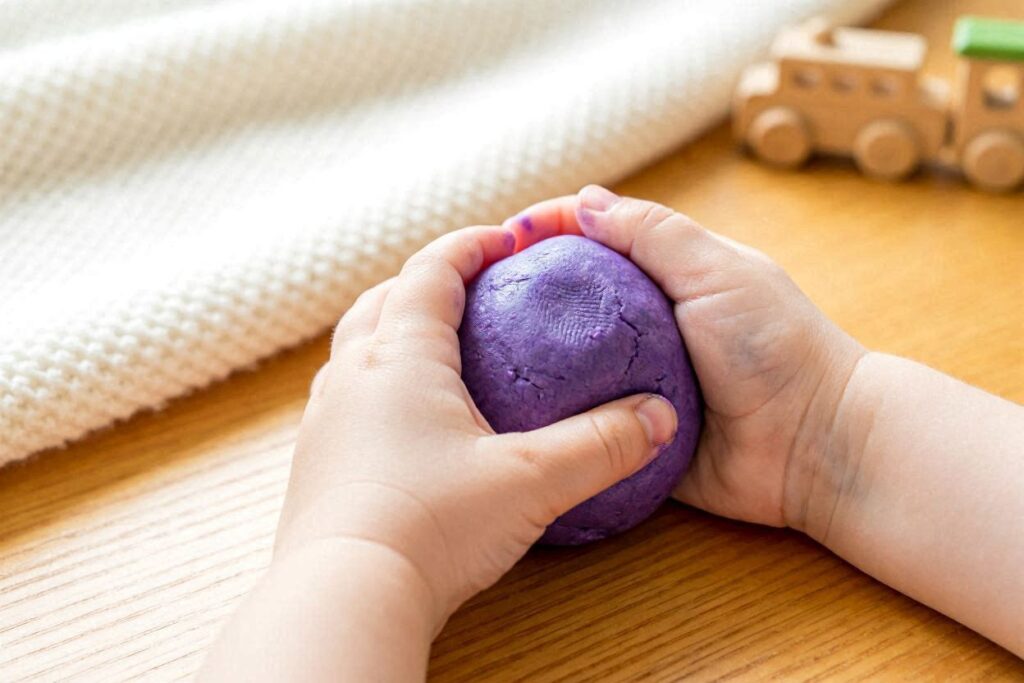 toddler rolling playdough into balls fine motor hand strength activity