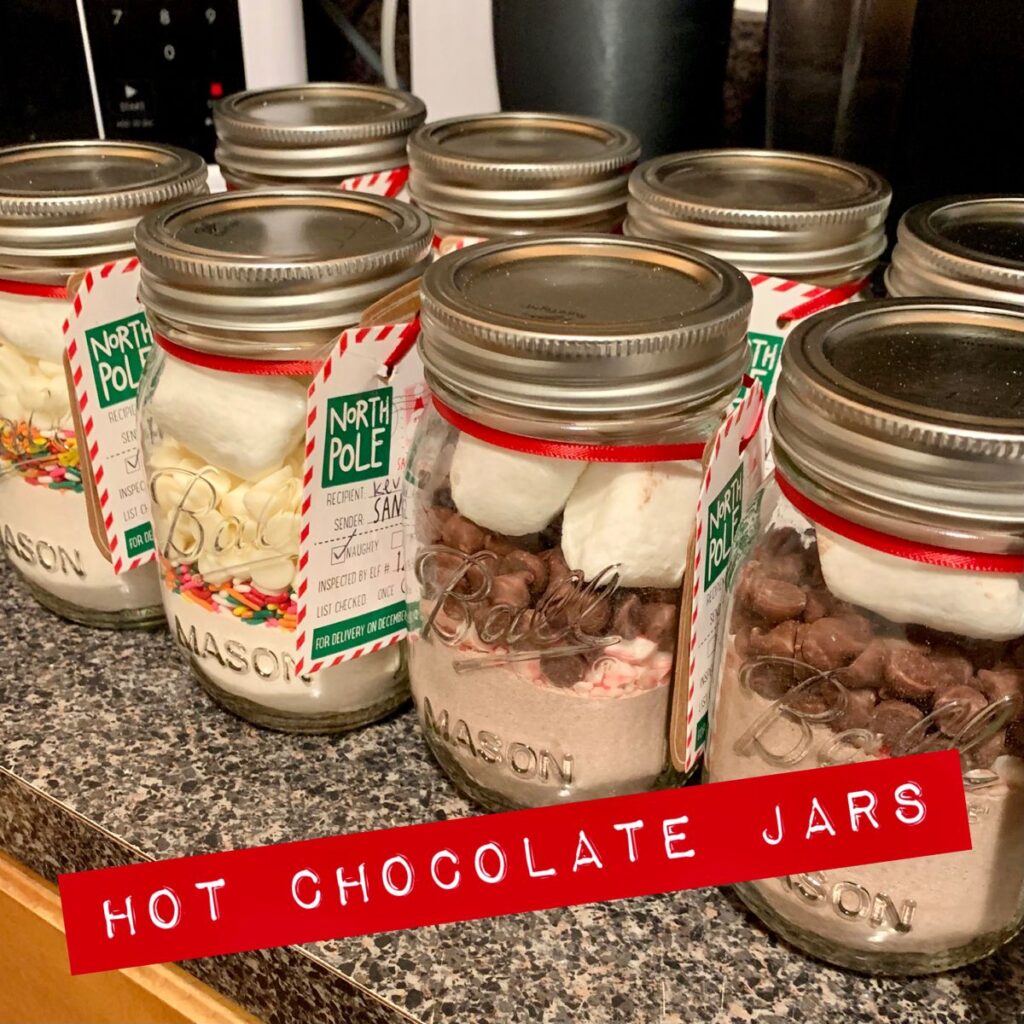 Homemade hot cocoa mix layered in a mason jar as a cozy Christmas gift treat