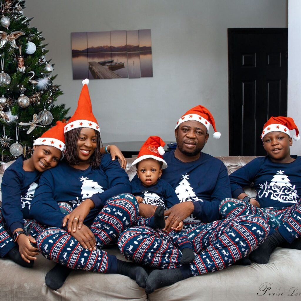 family in Christmas pajamas gathered around the Christmas tree on Christmas morning, Christmas Day traditions